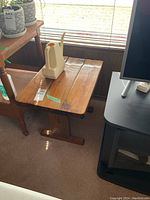 Solid wood side table with drawer, showing top surface and wear, scratches, and water marks.