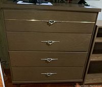 Front view of the dresser showing all four drawers with metal pulls