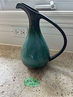 Front angle view of Blue Mountain Pottery pitcher showing shape and glaze color transition from dark blue to blue-green.