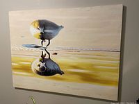 Full view of large canvas print featuring a bird and its reflection in water, highlighting the colors and overall condition.