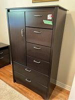 Front view of chest showing drawer arrangement and side door