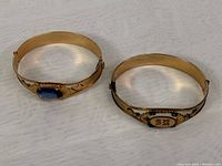 Two gold-filled hinged bangles side by side showing overall appearance