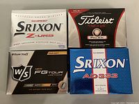 Four golf ball boxes including Srixon Z-URS, Titleist Pro V1x, Wilson Staff FG Tour, and Srixon AD333 displayed clearly from the top.