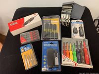 Full lot showing the JOBMATE rotary tool kit in box, screwdriver set, screwdriver pack, snap-on nut driver set in packaging, tweezers, and digital tire gauge.