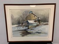 Full view of the framed watercolour painting showing the winter landscape setting with building and reflection in water, artist signature visible.