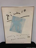 Full view of the framed Picasso promotional event poster picturing an abstract blue figure with event details for a 1985 Montreal Museum of Fine Arts exhibition.