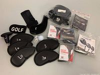 General overview of all golf accessories including head covers, torque wrenches, golf ball, and tools