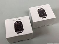 Two white boxes containing two generic smart watches, the boxes show the watch image and label "Smart Watch".