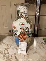 Porcelain vase front side showing colorful traditional Asian figures and calligraphy artwork.