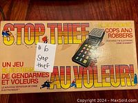 Top of box showing game title Stop Thief with picture of electronic scanner device, bilingual English/French text, and copyright date 1979.
