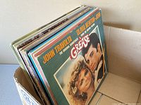 Box of vintage record albums with front album 'Grease' soundtrack visible on top