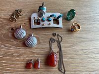 Overall view of all jewelry items on wooden surface
