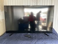 Front view of Samsung 55-inch LED TV powered off on padded surface