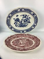 Two Masons England collectible platters displayed upright and flat showing distinct colors and patterns