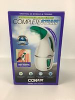 Front view of the box with image of the Complete Steam handheld travel steamer, highlighting features including 1100 watt power, spill protection, and ergonomic design.