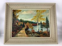 Full view of framed landscape painting showing river, trees, and path in autumn colors.