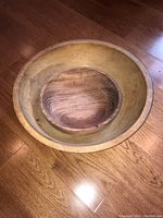Top view of two nested wooden bowls, smaller darker bowl inside larger lighter bowl
