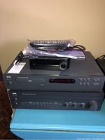 Stacked view of CD player C 542 atop amplifier C 352 with remote and cable on top