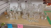 Front view showing crystal salt and pepper shakers, candle holders, and decanters