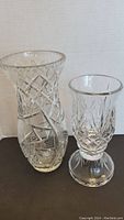 Photo of both the etched crystal vase and the two-piece hurricane candle stand showing their size and etched cut patterns.
