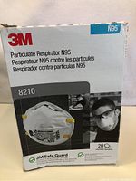 Box of 3M 8210 N95 particulate respirator masks showing front label and product images.