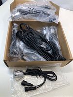 Photo of the box containing 10 LED deck lights, power supply, and connecting cables all sealed in plastic.