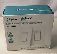 Box front displaying TP-Link Kasa Smart Wi-Fi Dimmer Switch 3-Way Kit with branding and compatibility information.