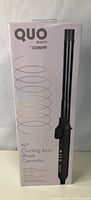 Photo of new in box Quo 3/4" curling iron by Conair with product packaging showing branding and product details.
