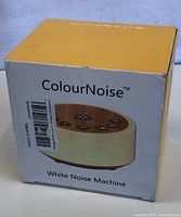Closed box of ColourNoise white noise machine showing brand name and product image.