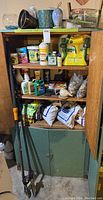 Overall view of shelving unit with planters, fertilizers, soils, tools and decorative items