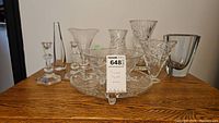 Overview of all crystal glassware items including candlestick holders, vases, candy dish, and footed platter