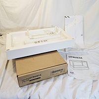 One pull out drawer insert displayed on top of its original cardboard box with instruction manual visible beside it. Shows overall condition and packaging.