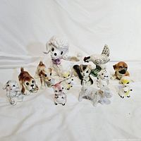 Photo showing lot of 12 vintage ceramic anamorphic animal figurines including dogs, cats, chicks, hen, and poodle planter, all in good vintage condition.