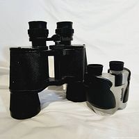 Both binoculars side by side on a white background showing relative sizes and finishes.