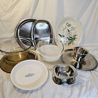 Overview of all glass and metal serving items together showing the diversity of platters, bowls and trays from different brands.