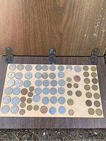 Full display of 69 assorted Hong Kong coins arranged on a wooden board showing different sizes and denominations.