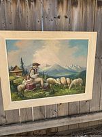 Frontal view of the signed oil painting in its frame showing the full rural landscape with figures and sheep.