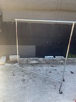 Full view of the garment rack showing sturdy chrome frame and hanging bar.