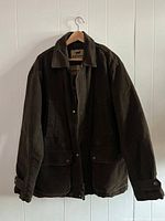 Front view of the brown duck coat showing the collar, flap pockets, and zipper snap closure.