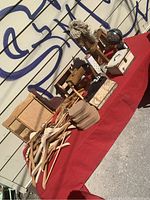 Large assortment of wooden treen and sundry items on red cloth with notable small boxes and mounted hook