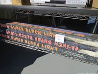 Photo showing 48-inch super black light tube in packaging and two black light fixtures.