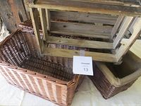 Three small baskets: one wooden crate-style basket and two wicker baskets in different shades and weaves shown together.