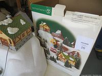 Full view of the Department 56 village gondola box and one house on snowy mountain base