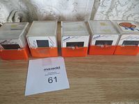 Photo showing five orange slide boxes containing photographic slides with handwritten year labels and brand markings.