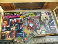Photo showing three Star Trek comic books and Star Trek III poster magazine with cast photos.