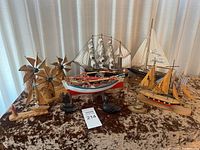 Full group shot of the maritime models including boats, windmills, and ducks on table
