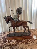 Front and side view of bronze sculpture of Cheyenne war chief on horseback.