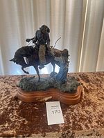 Full view of sculpture on wooden base