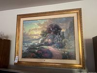 Frontal view of framed Thomas Kinkade print showing landscape and frame