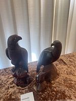 Set of three wood carved eagles on display showing size and detail differences